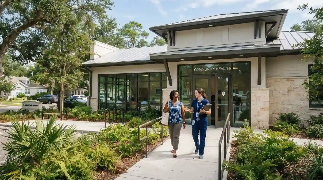 Modern community healthcare center in St. Augustine, Florida with a welcoming entrance and patients arriving for care.