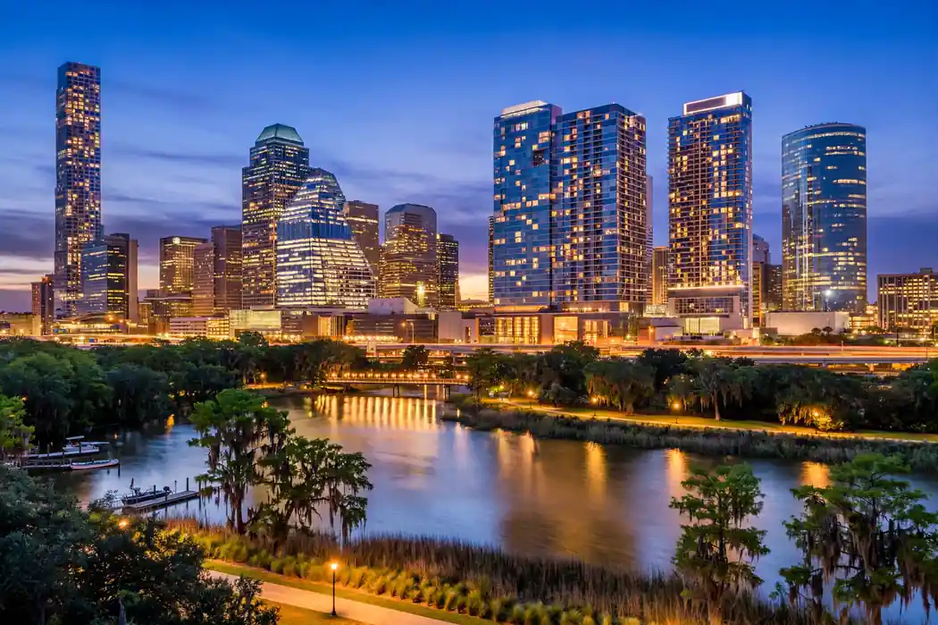 Downtown Houston skyline and hotel towers at blue hour with warm city lights