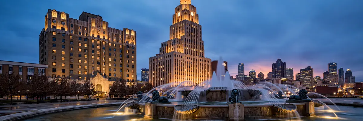 Kansas City downtown skyline and historic hotel buildings at dusk with art deco towers and warm lights
