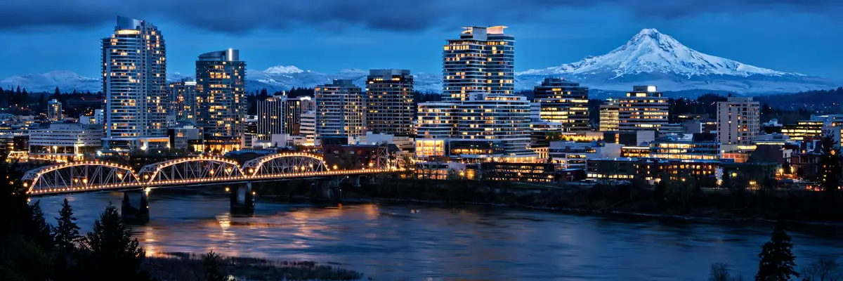 Best hotels in Portland – downtown skyline with Mount Hood across the river at blue hour