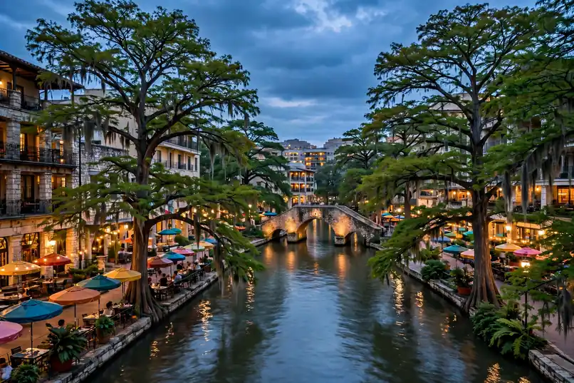 San Antonio River Walk with riverside hotels, stone bridges and cypress trees at dusk