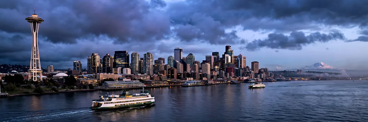 Best hotels in Seattle – downtown skyline with Space Needle across Elliott Bay at blue hour